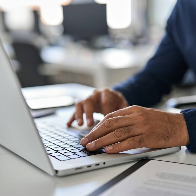 hands-of-business-man-typing-on-laptop-working-with-ai-solutions-on-computer-.jpg